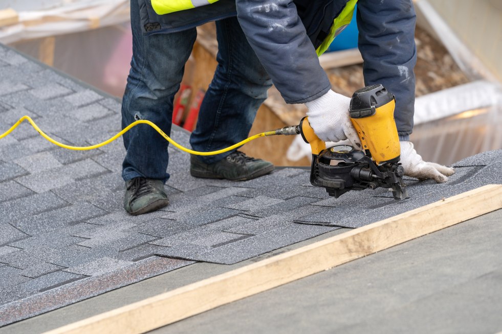 Asphalt shingles being installed on new home 